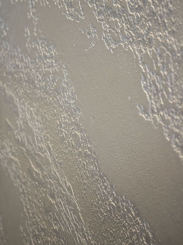 Dettagli rivestimento in calce di colore grigio effettuato su una parete